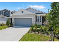 Charming single-Gathering home with a gray garage door and stone accents on the front facade at 6397 Clover St, Lake Hamilton, FL 33851