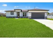 Charming single-story home with a well-manicured lawn and stone accents at 370 Marion Oaks Crse, Ocala, FL 34473