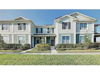 Inviting townhome with manicured lawn, complemented by neat landscaping and a bright, sunny sky at 4710 Nathan Hale Blvd, St Cloud, FL 34769