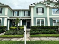 Inviting two-story townhouse with a well-manicured lawn and coordinated exterior colors at 4710 Nathan Hale Blvd, St Cloud, FL 34769