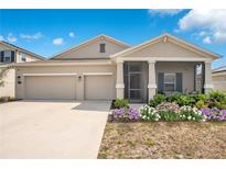 Charming one-story home with a three-car garage, inviting porch, and beautiful landscaping at 109 Pineywoods St, St Cloud, FL 34772