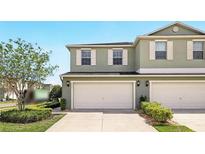 Two-story home featuring a two-car garage, neutral paint, complemented by well-maintained landscaping and bright natural light at 3341 Rodrick Cir, Orlando, FL 32824