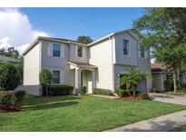 Charming two-story home with a well-maintained lawn and mature landscaping, perfect for families or anyone seeking a cozy neighborhood at 1039 Tourmaline Dr, Kissimmee, FL 34746