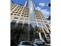 Modern building with sleek architecture and a mix of concrete and glass facade in an urban setting at 155 S Court Ave # 1308, Orlando, FL 32801