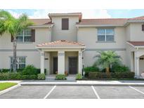 Charming townhouse with a red tile roof, neutral exterior, and well-maintained landscaping at 4888 Romeo Cir, Kissimmee, FL 34746