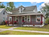 Charming two-story home with a quaint covered porch and inviting curb appeal at 514 Massachusetts Ave, St Cloud, FL 34769