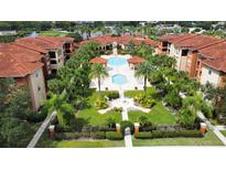 Beautiful aerial view showcasing the community pool and lush landscaping in a tropical setting at 5560 Metrowest Nw Blvd # 106, Orlando, FL 32811