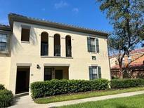 Charming two-story home with arched balconies and manicured landscaping at 1000 Via Santae Ln # 201, Kissimmee, FL 34747