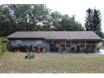 Charming single-story home featuring a well-maintained lawn and mature trees at 206 Willow St, Lake Wales, FL 33859