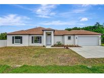 Charming single-story home with a well-manicured lawn, attached garage and a beautiful roof at 250 Beckenham Dr, Kissimmee, FL 34758