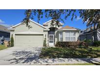 Charming single-Gathering home with a well-manicured lawn and mature landscaping at 2713 Barnsley Ln, Kissimmee, FL 34744