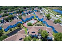 A vibrant apartment community offers a tennis court and lush landscaping near a tranquil pond at 2725 N Poinciana Blvd # 147, Kissimmee, FL 34746