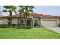 Inviting single-story home with mature landscaping, manicured lawn, and a terracotta tiled roof at 4072 Oaktree Dr, Davenport, FL 33837