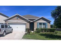 Charming one-story home featuring a two-car garage, well-maintained lawn, and neutral color palette at 4147 Sherlock Ct, Orlando, FL 32824