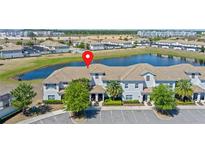 Community aerial view showcasing a stunning lakeside townhome with tile roof at 4907 Romeo Cir, Kissimmee, FL 34746