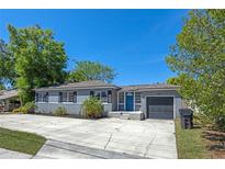Charming single-story home with a well-manicured lawn, gray paint, a driveway, and a one car garage at 1316 N Bumby Ave, Orlando, FL 32803
