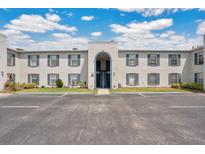 Exterior of condominium complex with blue shutters and a well-maintained parking lot at 1038 Plantation Dr # D9, Kissimmee, FL 34741