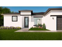 Beautiful new construction home with a modern design, manicured lawn, and beautiful landscaping at 16837 Sw 47Th Court Rd Rd, Ocala, FL 34473