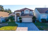 Charming two-story home featuring an attached two-car garage and a meticulously maintained front yard at 2110 Korat Ln, Maitland, FL 32751