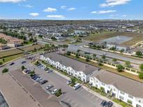 A high, scenic aerial view showcasing the community's layout, with a pond and surrounding landscape at 2408 Dubai St, Kissimmee, FL 34747
