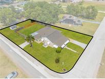 Aerial view of charming single Gathering home featuring a spacious fenced yard with mature trees at 1422 Missouri Ave, St Cloud, FL 34769