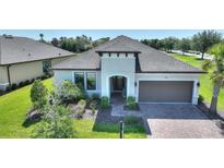 Charming single-story home featuring a two-car garage, well-maintained landscaping, and a brick-paved driveway at 1948 Molise Dr, Kissimmee, FL 34759