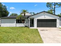Charming single-story home featuring a well-maintained lawn and attached two-car garage at 2506 Bali Cir, Kissimmee, FL 34741