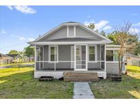 Charming home features a cozy screened porch, offering a perfect spot to relax and enjoy the outdoors at 503 New York Ave, St Cloud, FL 34769