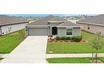 Charming single-story home with gray exterior, well-manicured lawn, and long driveway at 5310 Preserve Blvd, St Cloud, FL 34772
