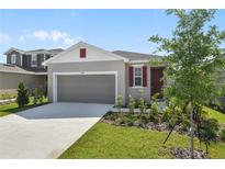 Charming one-story home with a two-car garage, landscaped yard and neutral exterior at 6385 Clover St, Lake Hamilton, FL 33851
