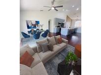 Bright open-concept living room featuring a modern kitchen, dining area, and comfortable seating at 738 Leonardo Ct, Kissimmee, FL 34758