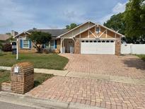 Charming single-story home featuring a well-maintained front yard and brick driveway at 1512 Ison Ln, Ocoee, FL 34761