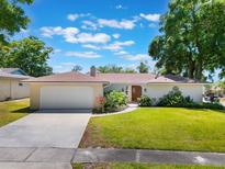 Charming single-story home with a well-manicured lawn, two-car garage, and lovely landscaping at 580 S Indigo Rd, Altamonte Springs, FL 32714