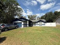 Charming single-story home featuring well-maintained landscaping and an attached garage at 6922 Doehring Dr, Lakeland, FL 33810