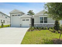 Charming single-Gathering home with a well-maintained lawn and a three car garage at 317 Alexandrite St, Deland, FL 32720