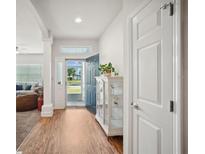 Inviting entryway featuring wood floors, ample natural light, and an open view to the living area at 3633 Bristol Cove Ln, St Cloud, FL 34772