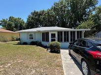 Charming single-story home with a well-maintained front yard and mature trees in a peaceful neighborhood at 406 E Grove Ave, Lake Wales, FL 33853