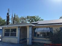Modest home with solar panels and an enclosed front porch at 2117 Lemon St, Haines City, FL 33844