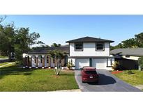 Two story home boasts a well manicured lawn and updated facade at 2227 Coventry Dr, Winter Park, FL 32792