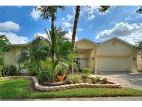 Inviting single-story home featuring a paver driveway, manicured landscaping, and a charming gated courtyard at 271 Falling Waters Dr, Kissimmee, FL 34759