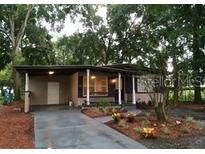 Charming single-story home with a covered carport, front porch, and well-maintained landscaping at 415 Calhoun Pl, Orlando, FL 32801