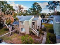 Aerial view of the home overlooking a lake and featuring a private stairwell at 6040 Peregrine Ave # A01, Orlando, FL 32819