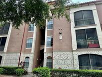 Three-story condo building featuring a combination of tan and off-white exterior walls at 6141 Metrowest Blvd # 303, Orlando, FL 32835