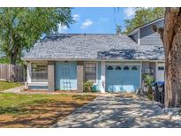 Charming single Gathering home featuring a blue exterior, a garage, and a well-maintained front yard at 7218 Alston Ct, Orlando, FL 32835