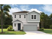 Charming two-story home featuring a modern design, two-car garage, and beautifully landscaped yard at 824 Lake Dell Rd, Dundee, FL 33838