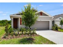 Charming single-story home with a two-car garage and well-manicured lawn, offering great curb appeal at 832 Lake Dell Rd, Dundee, FL 33838