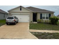 Charming single-story home with a two-car garage and well-maintained lawn at 1104 Star Ruby Ln, Winter Haven, FL 33880