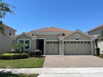 Charming one-story home featuring a tile roof, well-manicured landscaping, and a spacious two-car garage at 1116 Blackwolf Run Rd, Davenport, FL 33896