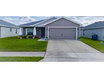 Charming single-story home with well-maintained lawn, landscaping, and a two car garage at 2059 Dexter St, Haines City, FL 33844