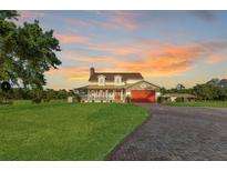 Charming two-story home featuring a brick driveway, large front lawn, and a welcoming front porch at 3255 Tucker Ave, St Cloud, FL 34772